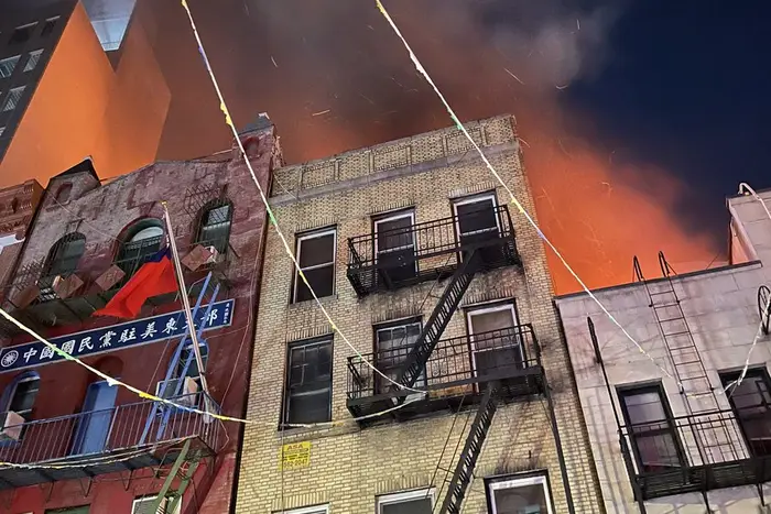 Firefighters battle to extinguish the flames in Chinatown early Sunday morning.